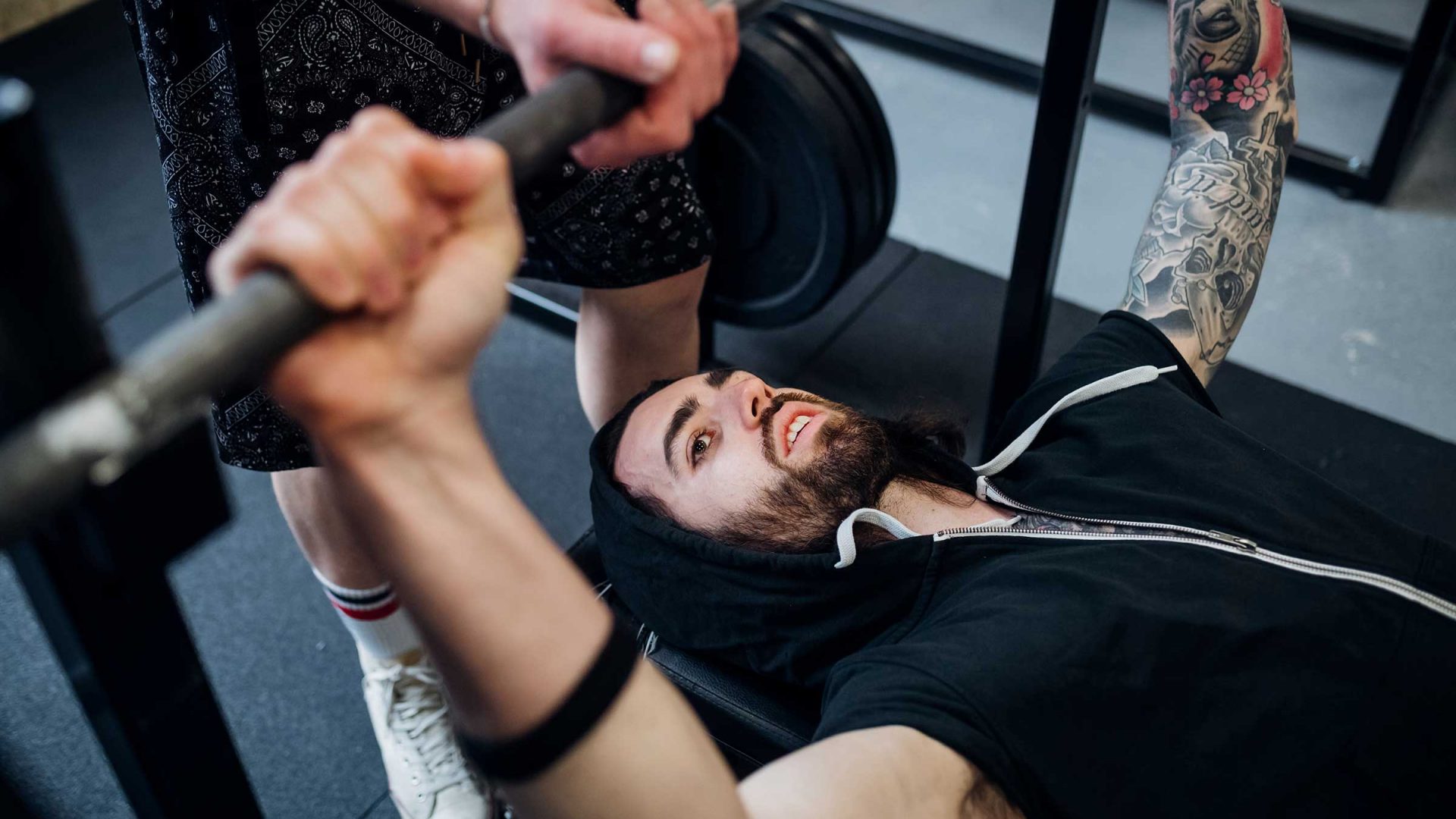 man-focusing-on-bench-pressing-in-a-gym-with-a-spo-2024-07-04-20-13-31-utc man-focusing-on-bench-pressing-in-a-gym-with-a-spo-2024-07-04-20-13-31-utc